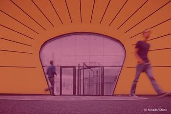 Bild eines Eingangsbereichs eines Universitätsgebäudes mit orangem Ornament und zwei Personen, Foto mit rotem Overlay und Beschriftung: B-First