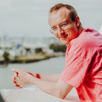 Porträt von Alex Paxton, auf dem Geländer der Elbphilharmonie-Plaza lehnend